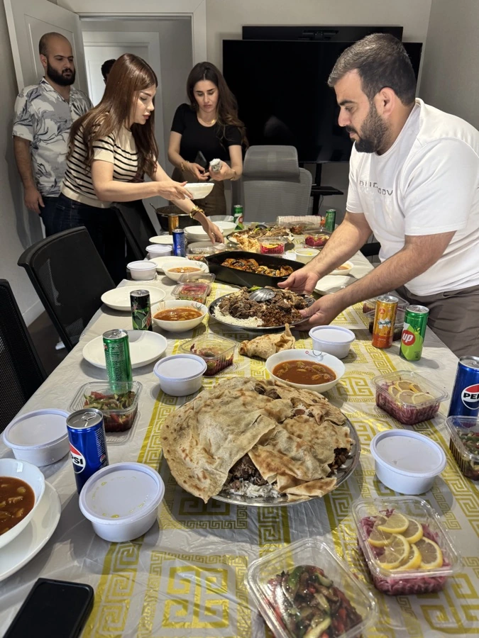 The team sharing a meal together around a full table